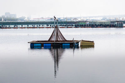 Gazebo by river against sky in city