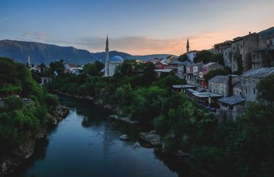 Scenic view of town against sky during sunset