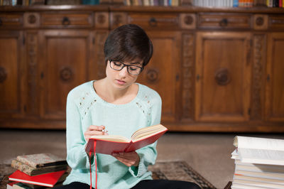 Mid adult man sitting on book