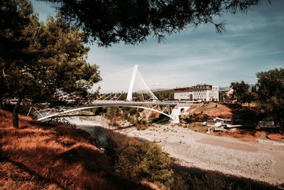 Bridge over road against sky in city