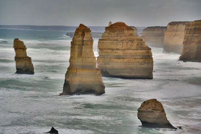 View of rock formation at beach during sunset