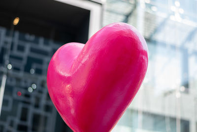 Close-up of heart shape with pink balloon