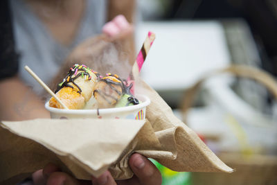 Close-up of hand holding ice cream