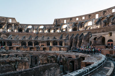 People at coliseum against clear sky