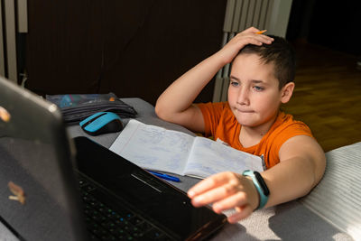 Boy studying online at home