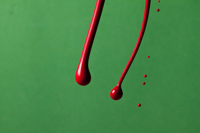 High angle view of red decoration on green background