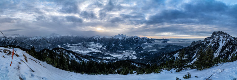 Scenic view of snow covered mountains against sky