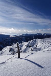 Snow covered landscape against sky