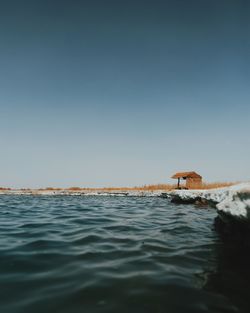 Sea with hut in background