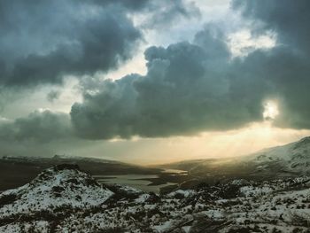 Scenic view of snow covered mountains against sky