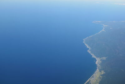 Aerial view of sea against clear sky during winter