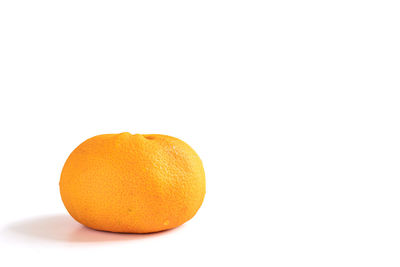 Close-up of orange fruit against white background