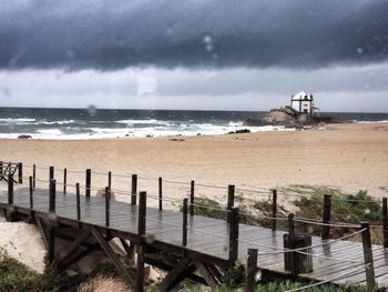 Scenic view of sea against cloudy sky