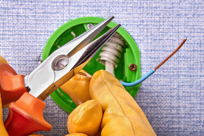 Cropped hands of electrician working on electrical equipment