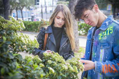 Young couple looking the flowers outdoors