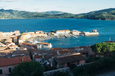 Boats in river with buildings in background