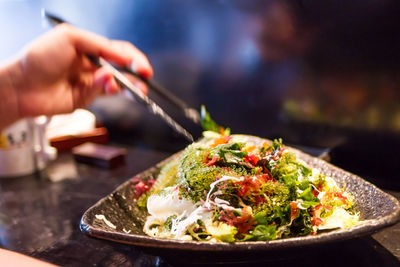 Close-up of hand holding food on table