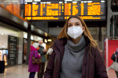 Traveler woman wearing medical face mask at the airport