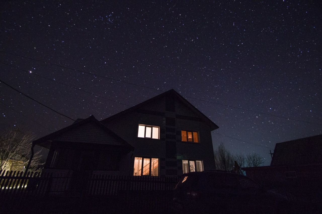 night, architecture, star - space, built structure, building exterior, low angle view, sky, astronomy, star field, house, window, tree, star, dark, no people, outdoors, nature, galaxy, infinity, scenics