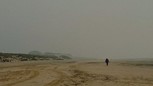 Man on beach against sky