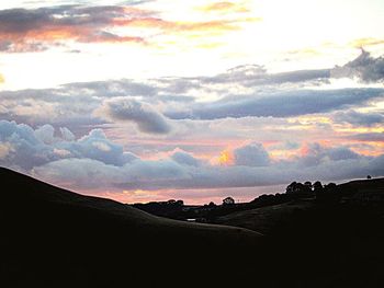 Scenic view of silhouette landscape against sky during sunset