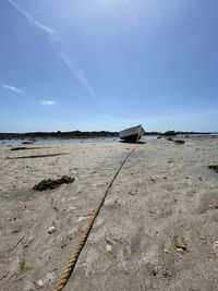 Scenic view of beach against blue sky