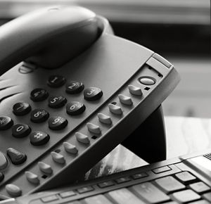 Close-up of computer keyboard and telephone