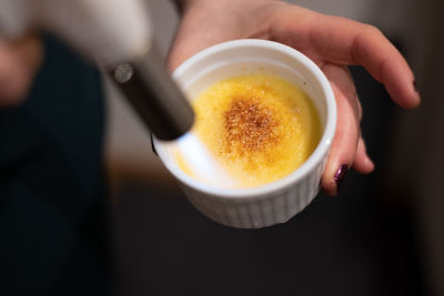 Creme brulee in a round white ceramic baking tin.