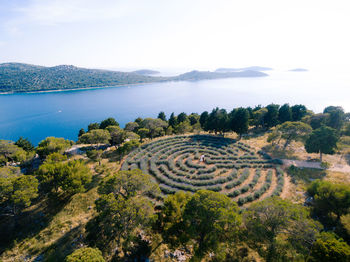 High angle view of land and sea against sky