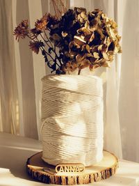 Close-up of flower vase on table at home