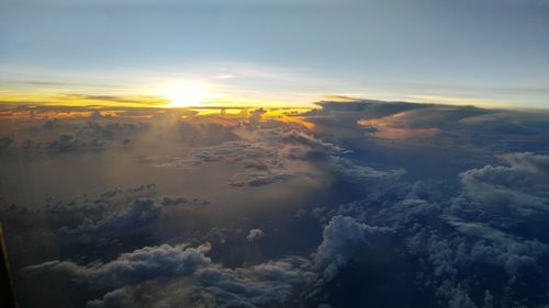 Aerial view of landscape against sunset sky