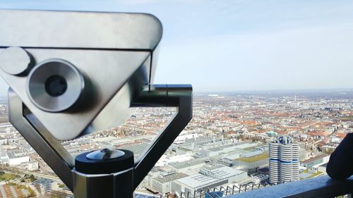Coin-operated binoculars overlooking cityscape