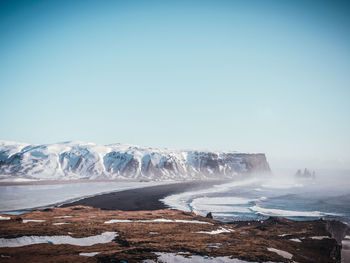 Scenic view of sea against clear sky during winter