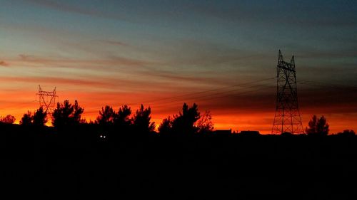 Low angle view of silhouette trees against sky at sunset