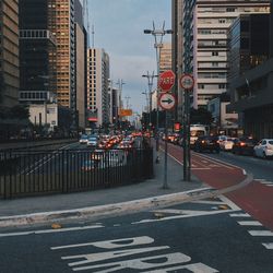 View of city street and buildings against sky