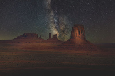 Scenic view of rock formation against sky at night