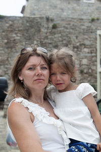 Portrait of mother and daughter outdoors