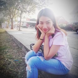Portrait of a smiling young woman sitting outdoors