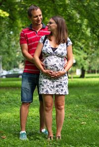 Full length of couple standing on grass