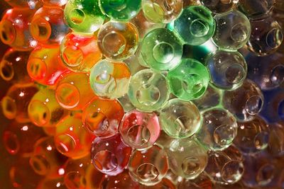 Full frame shot of multi colored candies in water