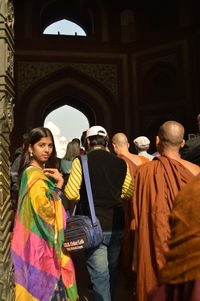 Rear view of people standing in temple