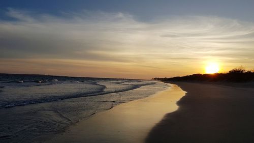 Scenic view of beach against sky during sunset