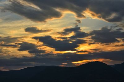 Scenic view of silhouette mountain against dramatic sky