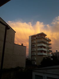 Low angle view of building against sky at sunset