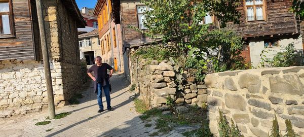 Full length of man standing on wall of building