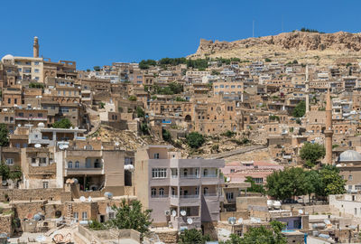 Buildings in town against clear blue sky