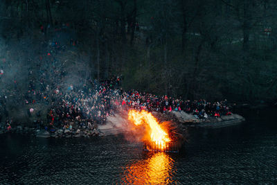 People by fire on water