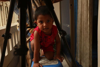 Portrait of girl crawling on floor