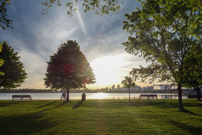 Scenic view of river against cloudy sky