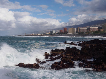 Scenic view of sea against cloudy sky